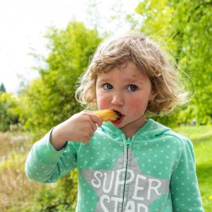 little girl eating a churro