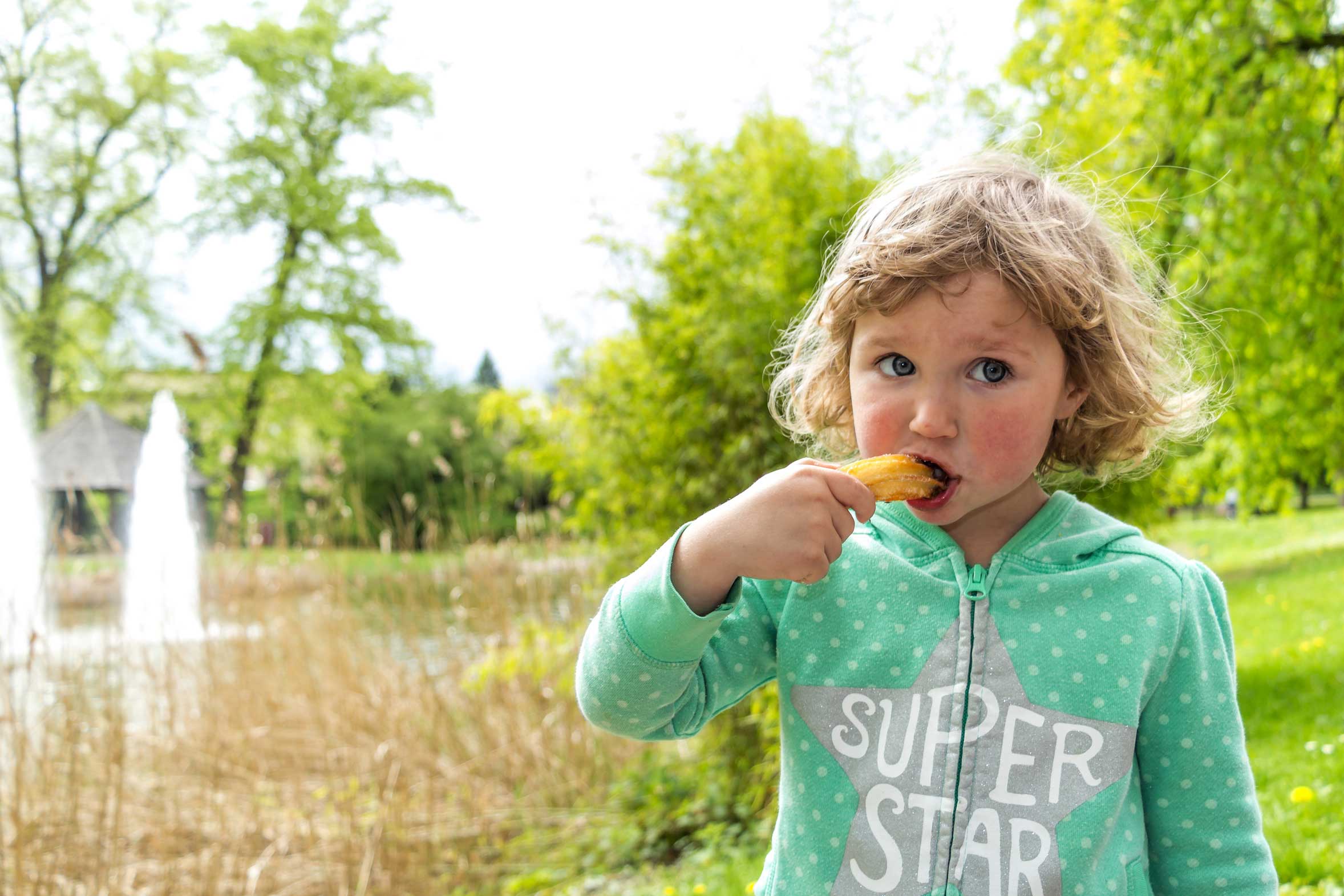 little girl eating a churro